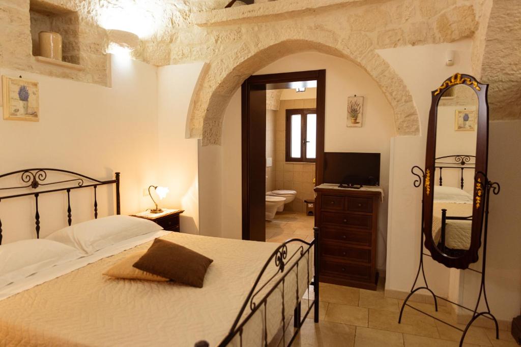 A bed or beds in a room at Quei Trulli Divini