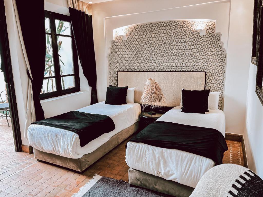 Postel nebo postele na pokoji v ubytování Riad Al Rimal & Spa