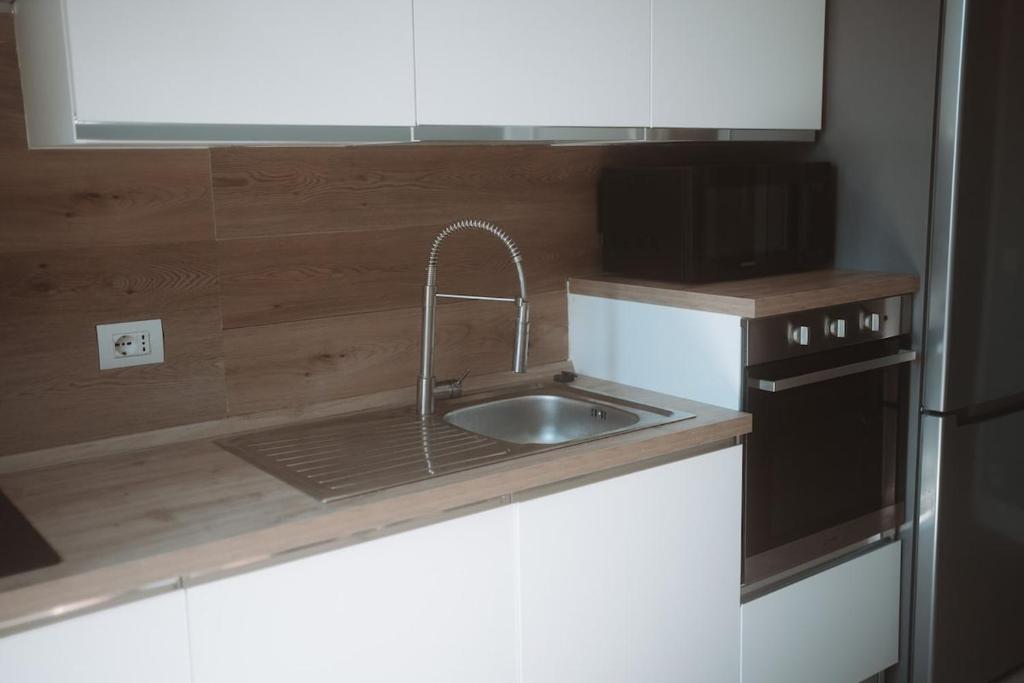a kitchen with a sink and a microwave at Borgo Pio Suite Apartment in Rome