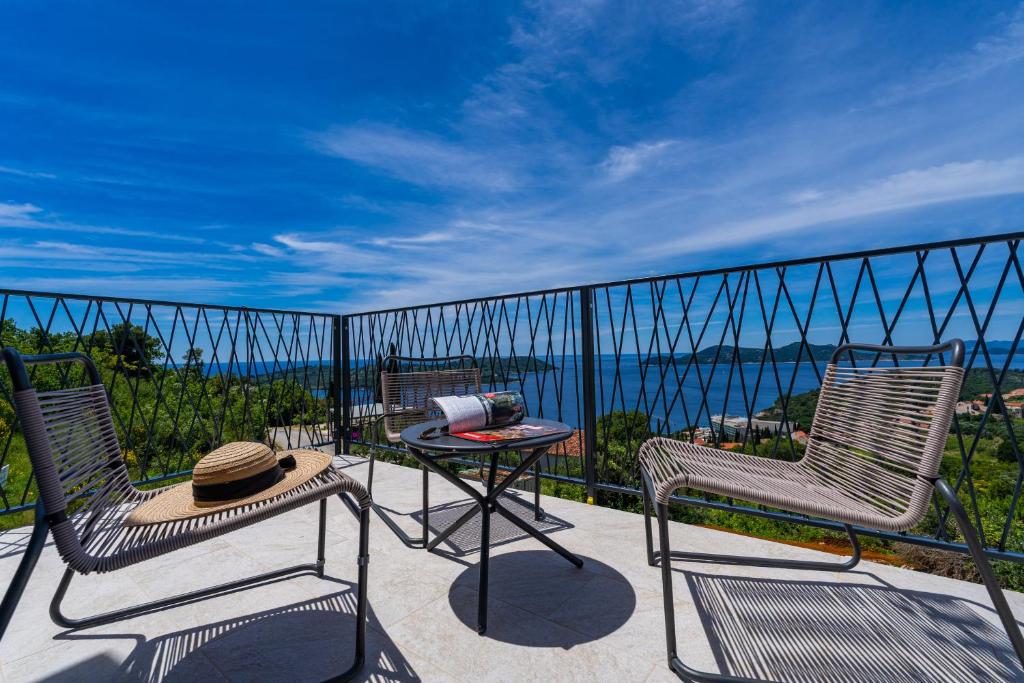 a patio with two chairs and a table on a balcony at Villa Leona in Dubrovnik