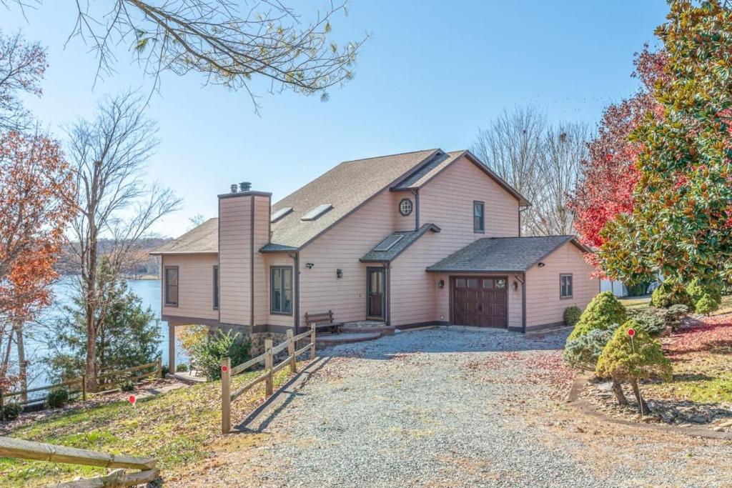 a large pink house with a driveway at Private Dock Lake Views & Outdoor Fun in Moneta