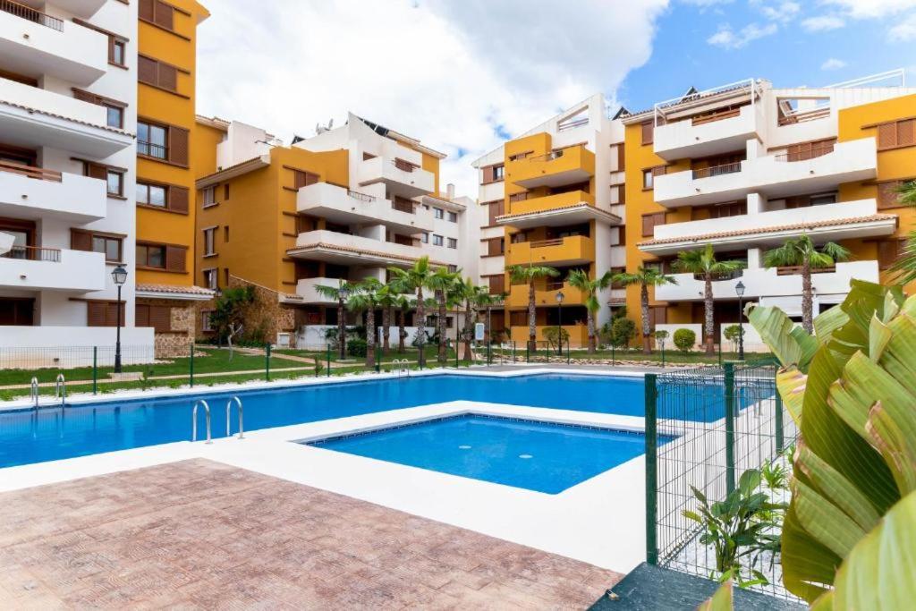 an image of an apartment complex with a swimming pool at CC8 VI by ZANIS in Torrevieja