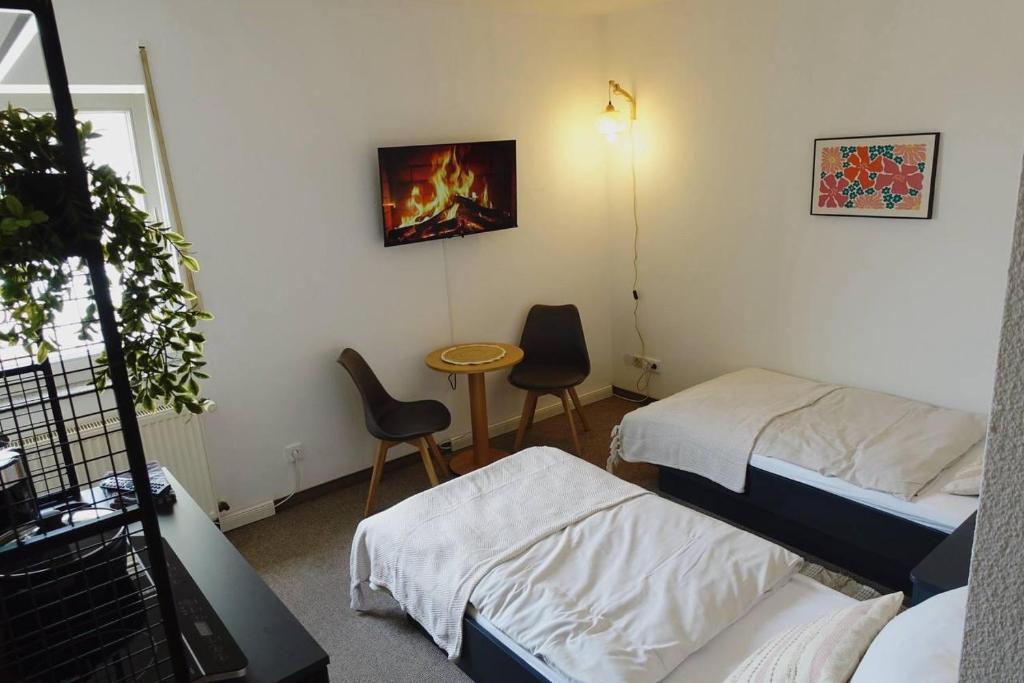Postel nebo postele na pokoji v ubytování Aparthotel Zur Linde - by Willms & Schömer eG