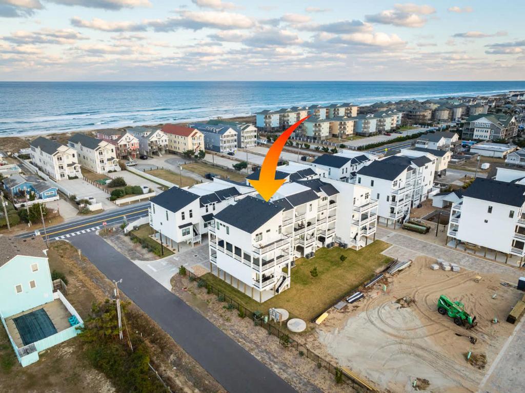an aerial view of a city with the ocean at New Build with Rooftop Deck & Panoramic Ocean Views in Kill Devil Hills