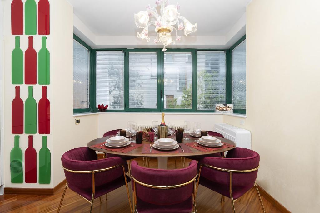 a dining room with a table and purple chairs at Ca' forte residence in Venice
