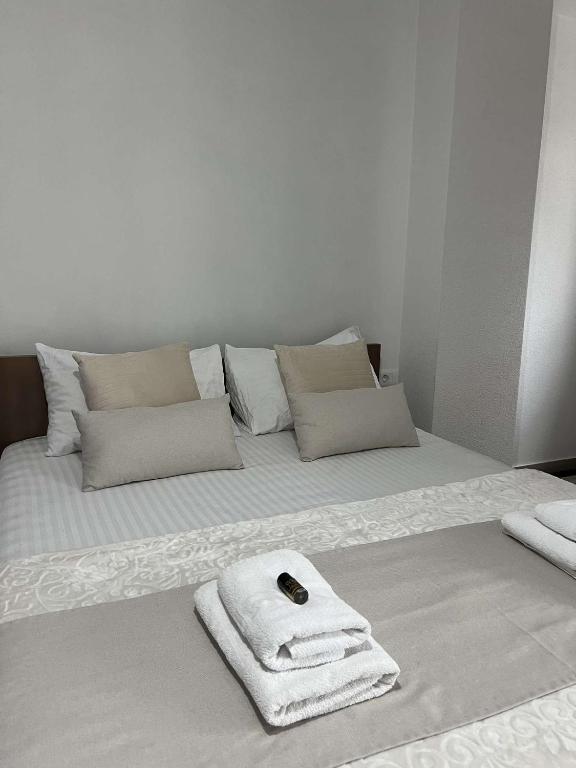 a white bed with a towel on top of it at Hotel Palace Struga in Struga