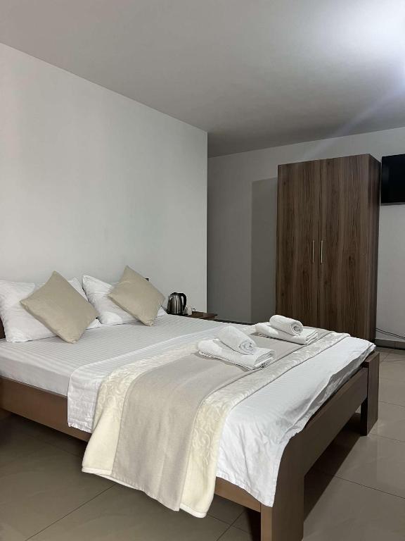 a bedroom with a large bed with towels on it at Hotel Palace Struga in Struga