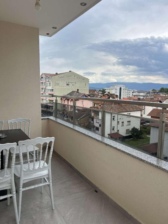 a balcony with a table and chairs and a view of a city at Hotel Palace Struga in Struga