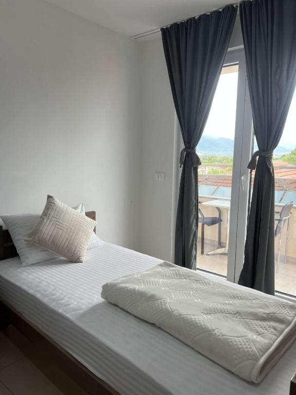 a bedroom with a bed and a window with a view at Hotel Palace Struga in Struga