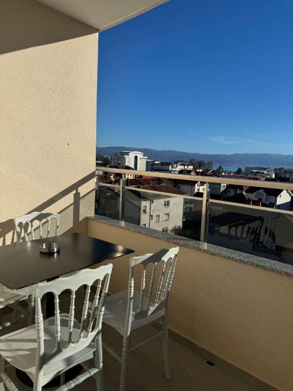 a table and chairs on a balcony with a view at Hotel Palace Struga in Struga