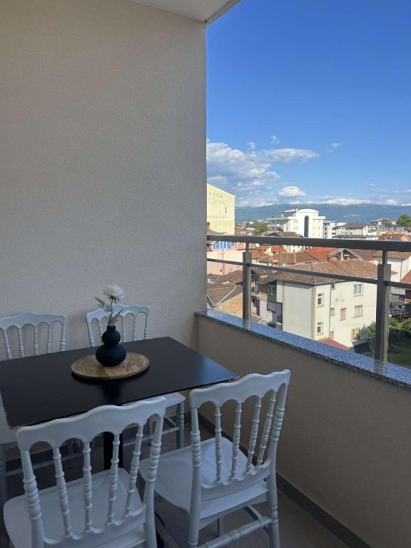 a table and chairs on a balcony with a view at Hotel Palace Struga in Struga
