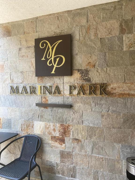 a sign for a marinana park on a brick wall at Marina Park OLIWIA in Sveti Vlas