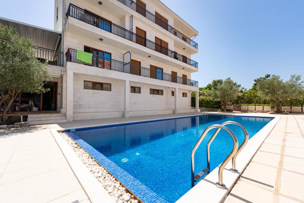 a swimming pool in front of a building at Apartments Dream in Tivat