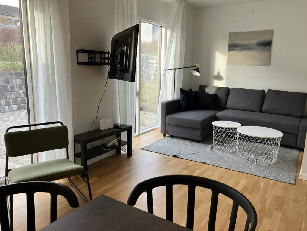 a living room with a couch and a table and chairs at Spacious Apartment for 7 in Sabro