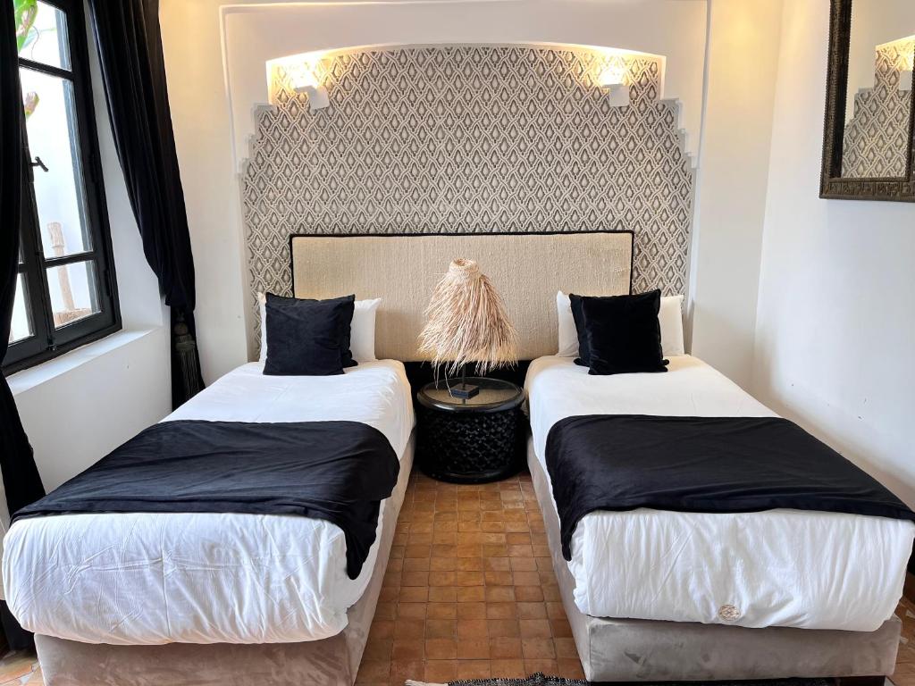 Postel nebo postele na pokoji v ubytování Riad Al Rimal & Spa