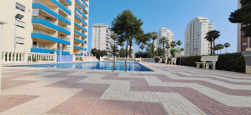 une piscine au milieu d'un immeuble dans l'établissement APARTAMENTO CALLE MENORCA A 100 MT del MAR, à Playa de Gandia