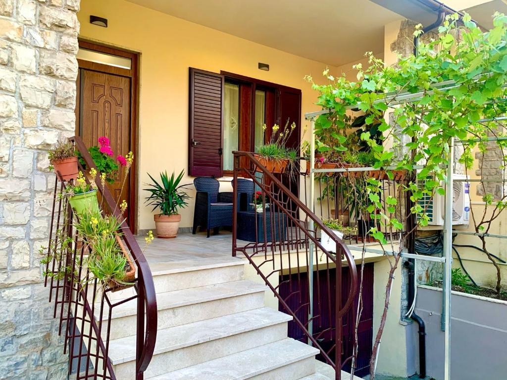 a house with a staircase with potted plants on it at Chianti 22 in Poggibonsi
