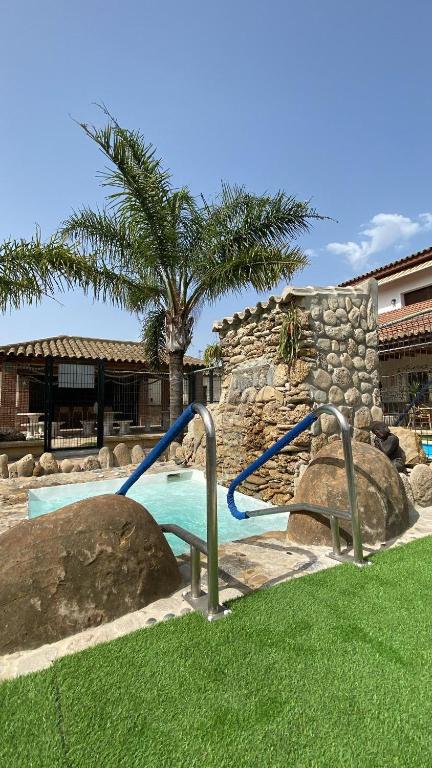 a swimming pool with a slide in a yard at Residencial La Teja in Zahora