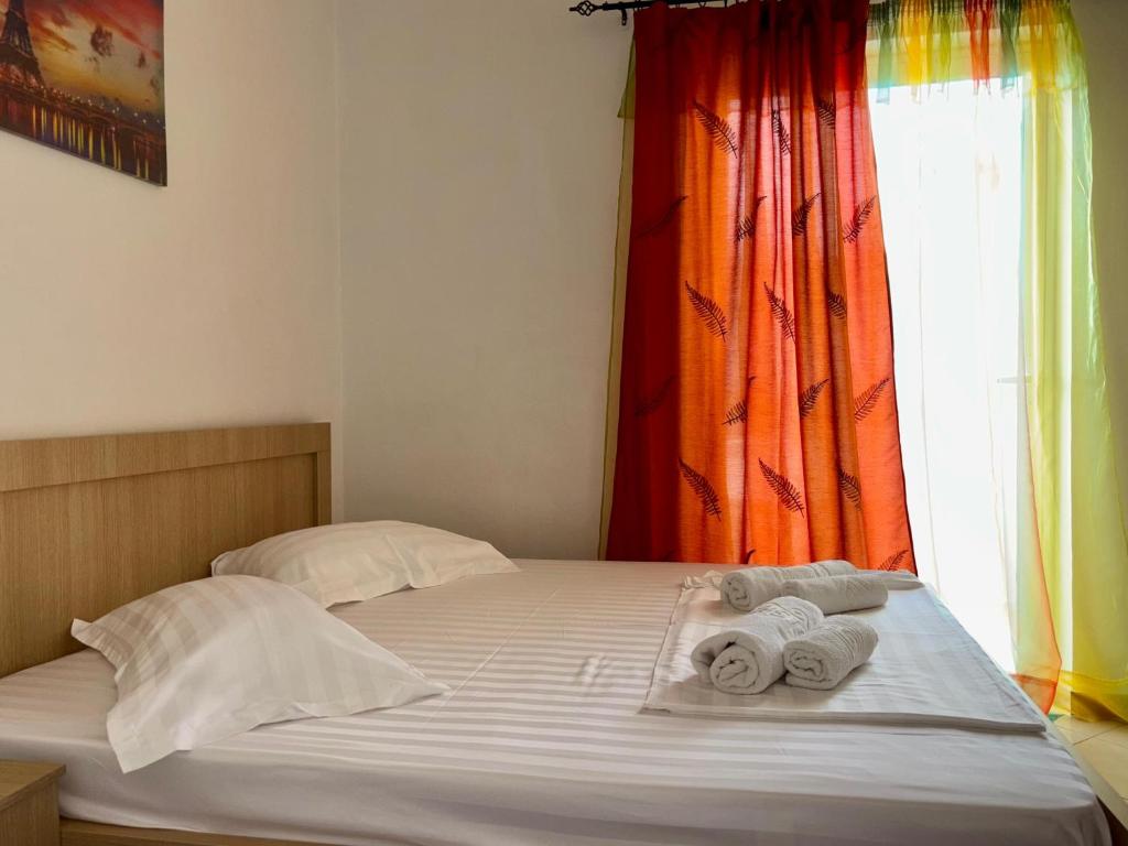 a bed with towels on it with a window at Vila Eqerem Dauti Ksamil in Ksamil