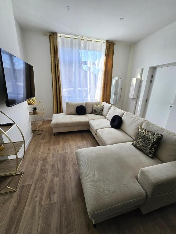 a living room with a couch and a flat screen tv at Chic & glamour Dubai Style in Flers-en-Escribeus