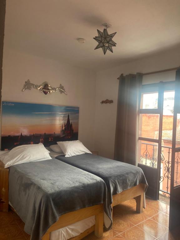 Postel nebo postele na pokoji v ubytování La Catrina Hostel