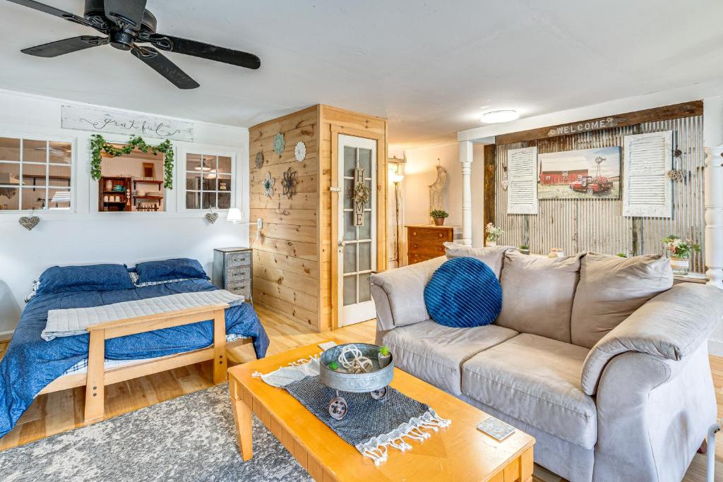 a living room with a couch and a bed at Lake and Mtn Views Vermont Couples Retreat! in Barton