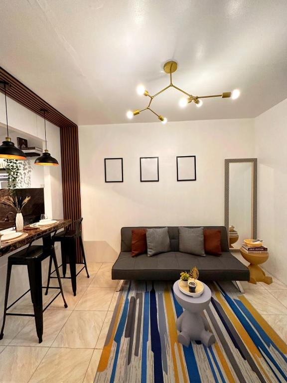 a living room with a couch and a table at The Lounge Platinum by KRD in Butuan