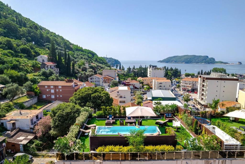 a resort town with a swimming pool and a city at Roof Top Villa Budva in Budva