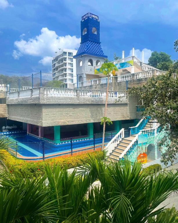 a building with a clock tower and a bridge at SGH Castillo Aqua in Santa Marta