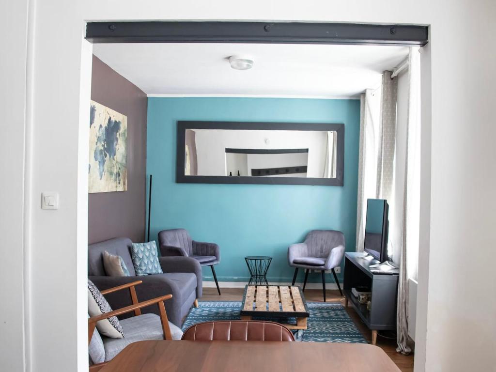 un salon avec un mur bleu dans l'établissement Terrace apartment - near city center - 4 bedrooms, à Reims