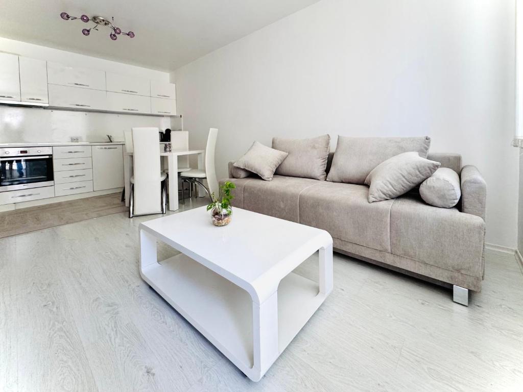 a living room with a couch and a table at Park suite in Burgas