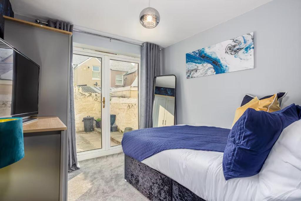 a bedroom with a bed and a large window at Room 1, 23 Deganwy Avenue in Llandudno