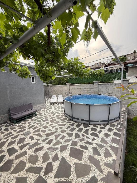 a patio with a hot tub and two chairs at Villa in Old Tbilisi in Tbilisi City