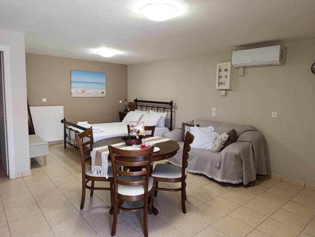 a room with a bed and a table and a couch at Anna's Cozy Home in Argostoli