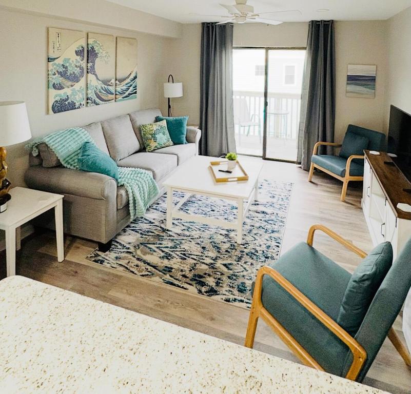 a living room with a couch and a table at Renovated OC Condo Walk to Beach Pool & Park in Ocean City