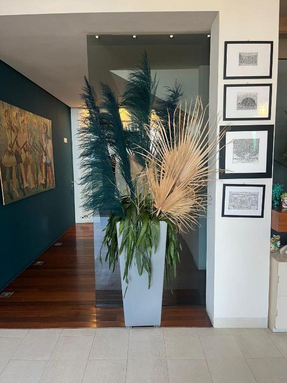 a large white vase with a plant in a hallway at Villa Olimpia in Mondello