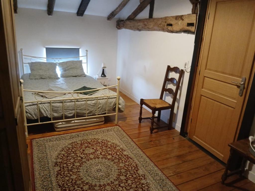 Postel nebo postele na pokoji v ubytování Gîte L'Ancienne Charcuterie