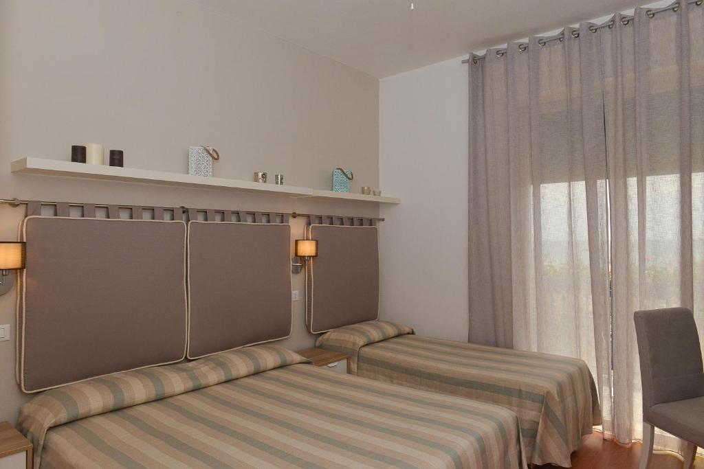 Postel nebo postele na pokoji v ubytování Hotel Conchiglia