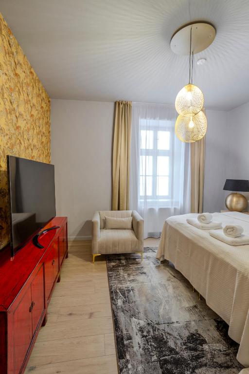 Postel nebo postele na pokoji v ubytování Apartmány U Devíti Lvů