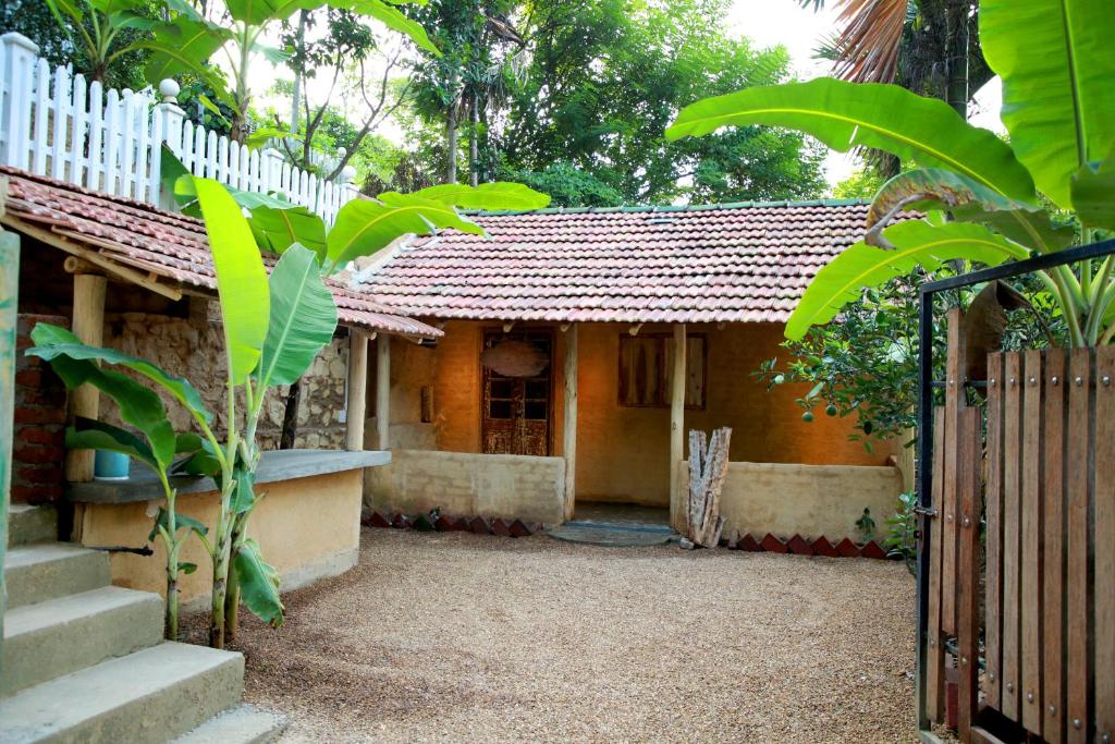 a small house with a gate and a fence at Ella Village House in Ella