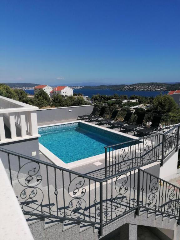 a view of a swimming pool on a balcony at Vila Kathy - kuća za odmor in Seget Vranjica