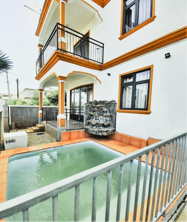 a house with a swimming pool on a balcony at Vacation House with Private Pool in Baie du Tombeau