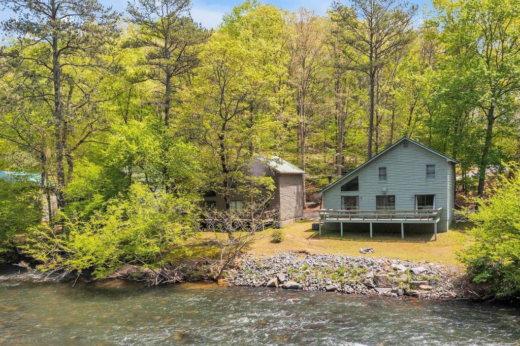 a house on the shore of a river at Coosawattee River Resort in Ellijay