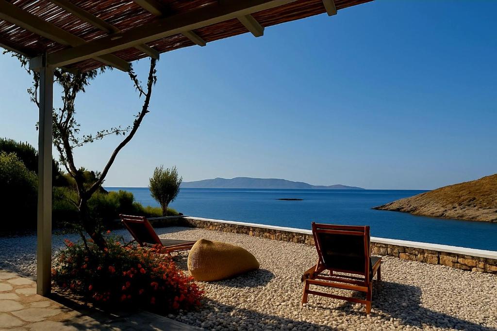 two chairs on a patio with a view of the water at Simousea in Kithnos