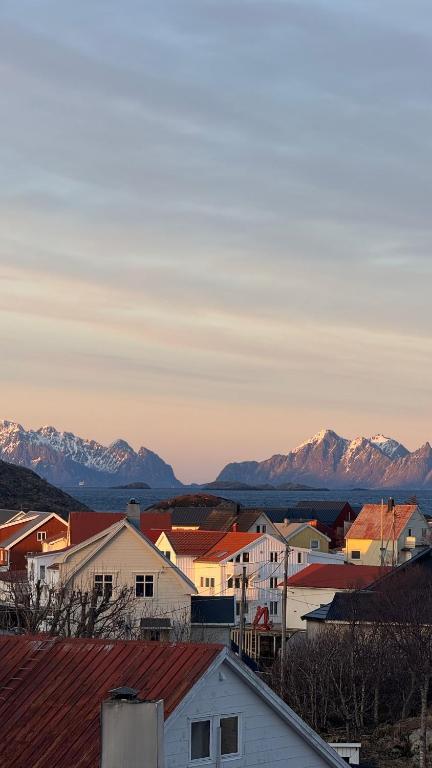 a city with houses and mountains in the background at Panoramic views in Henningsvær in Henningsvær