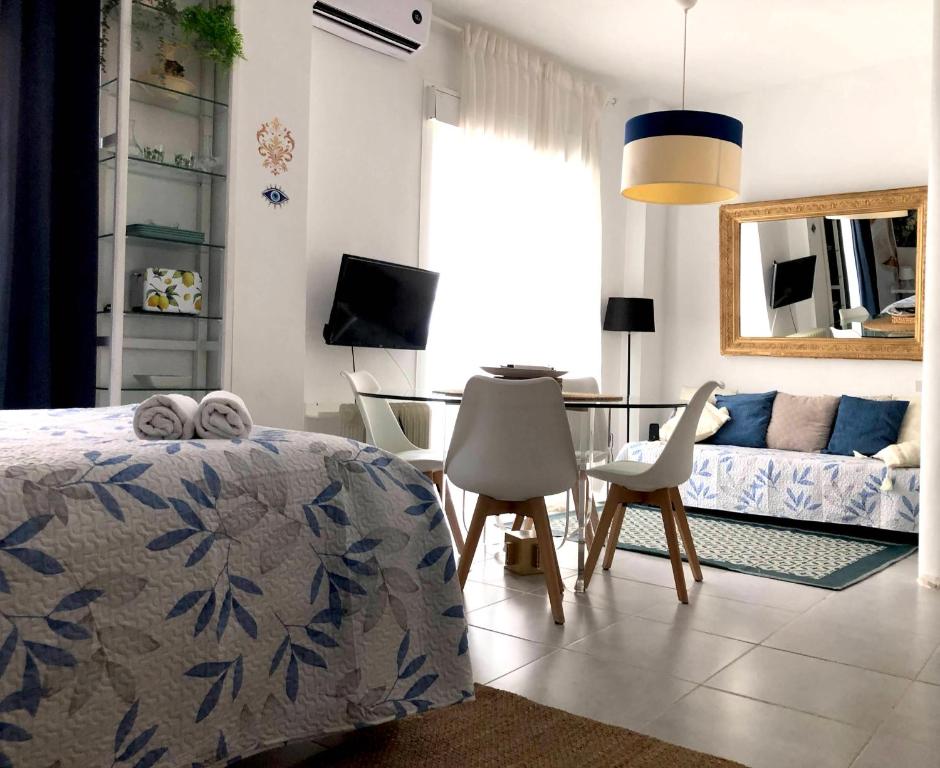 a bedroom with a bed and a table and a couch at La Gitana y El Rey Sol in Málaga