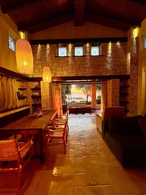 a dining room with a table and a brick wall at Harmony Home in Pyrgos