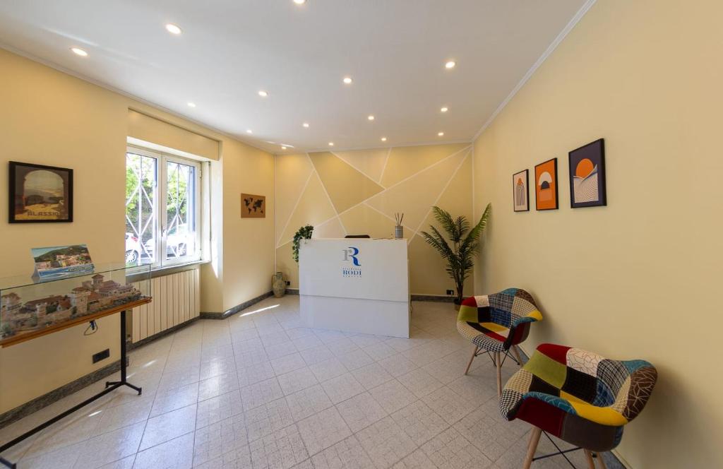 a large room with chairs and a refrigerator at Residence Rodi in Alassio
