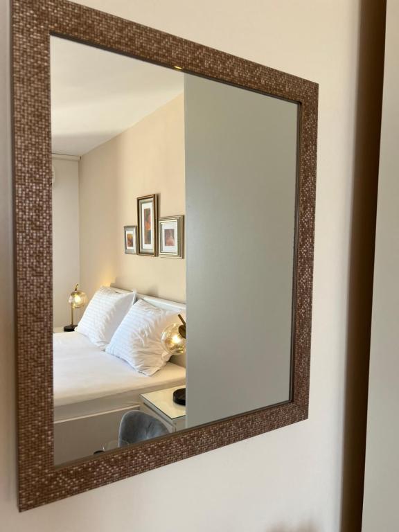 a mirror on a wall next to a bed at Villa Marie in Baška Voda