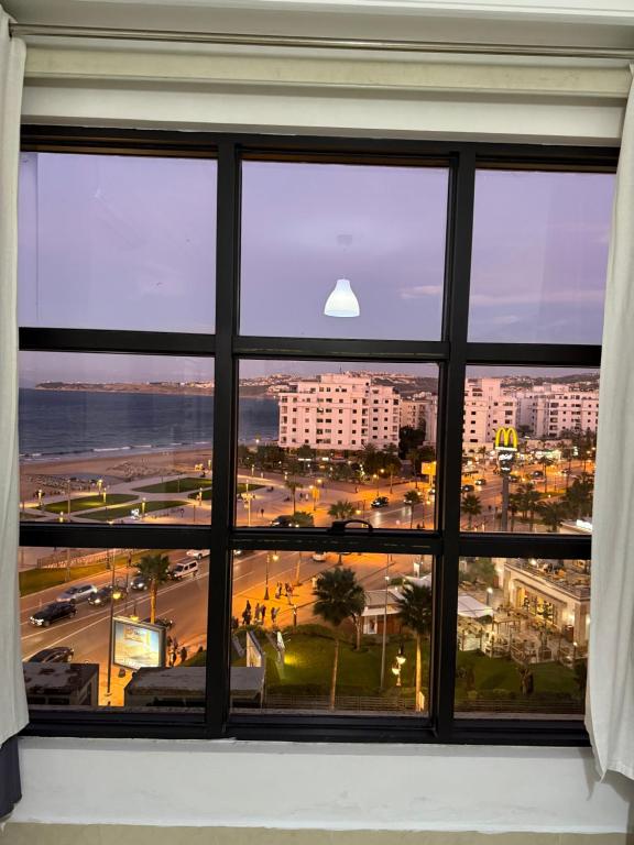 a view of a city from a window at Une pépite avec vue panoramique playa, Tanger in Oulad Akkou